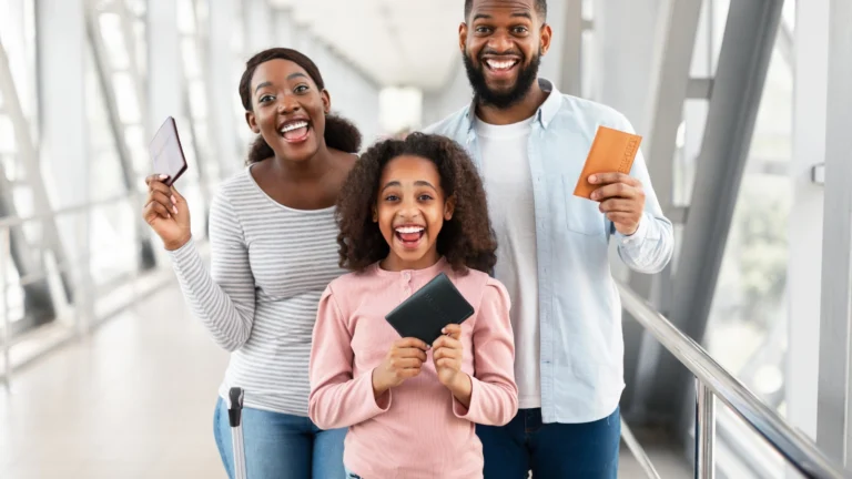 Happy family at MSP Airport holding passports and tickets. This airport just snagged the title of America's top airport – find out what makes it a favorite among travelers!