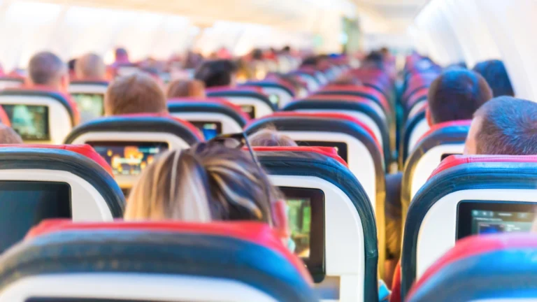 Airplane passengers seated. Ever wondered which side of the plane gives you the best experience? Frequent fliers spill their secrets on the ultimate seat selection!