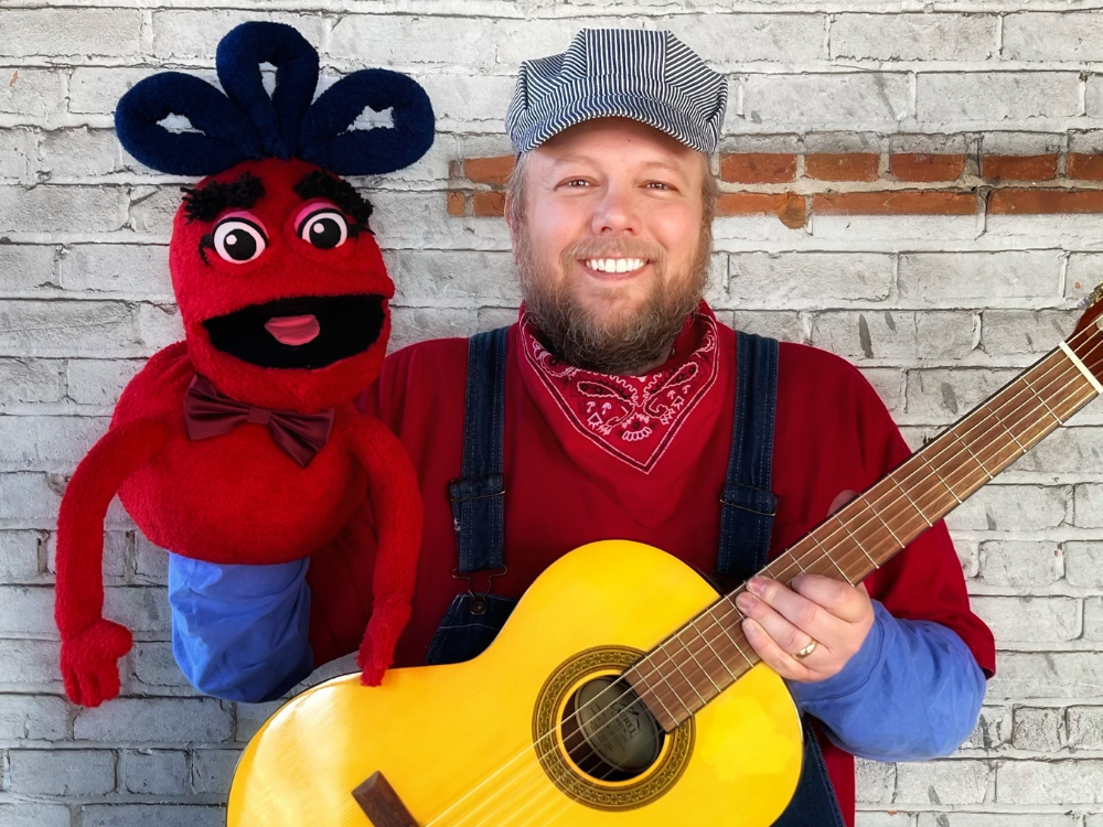 Conductor Jack (with acoustic guitar) and puppet friend NayBob